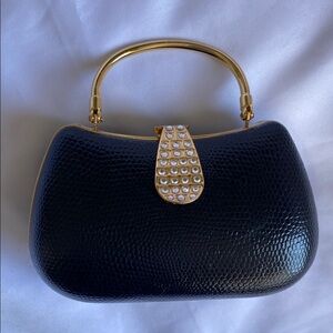 Elegant Black Mini Handbag with Gold Accents & Shoulder Strap
